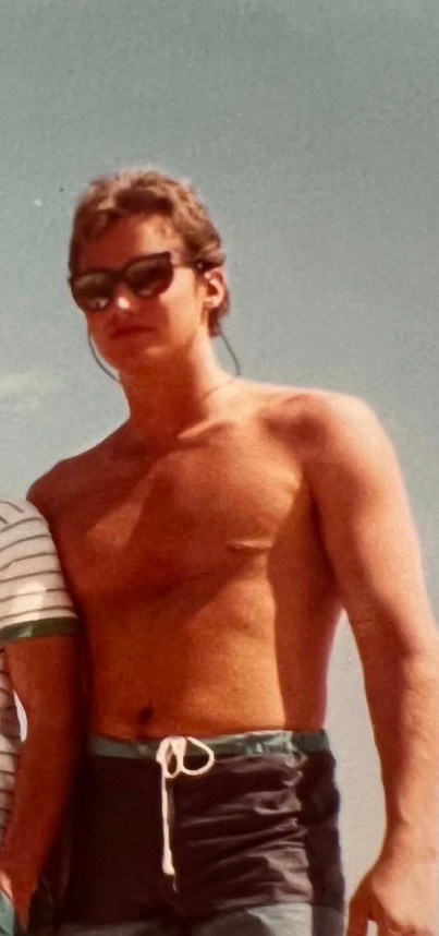 Michael Vos at the beach, in sunglasses, on a summer day.