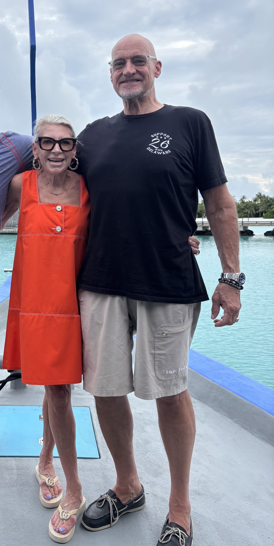 Michael and a friend on a dock beside a lagoon.